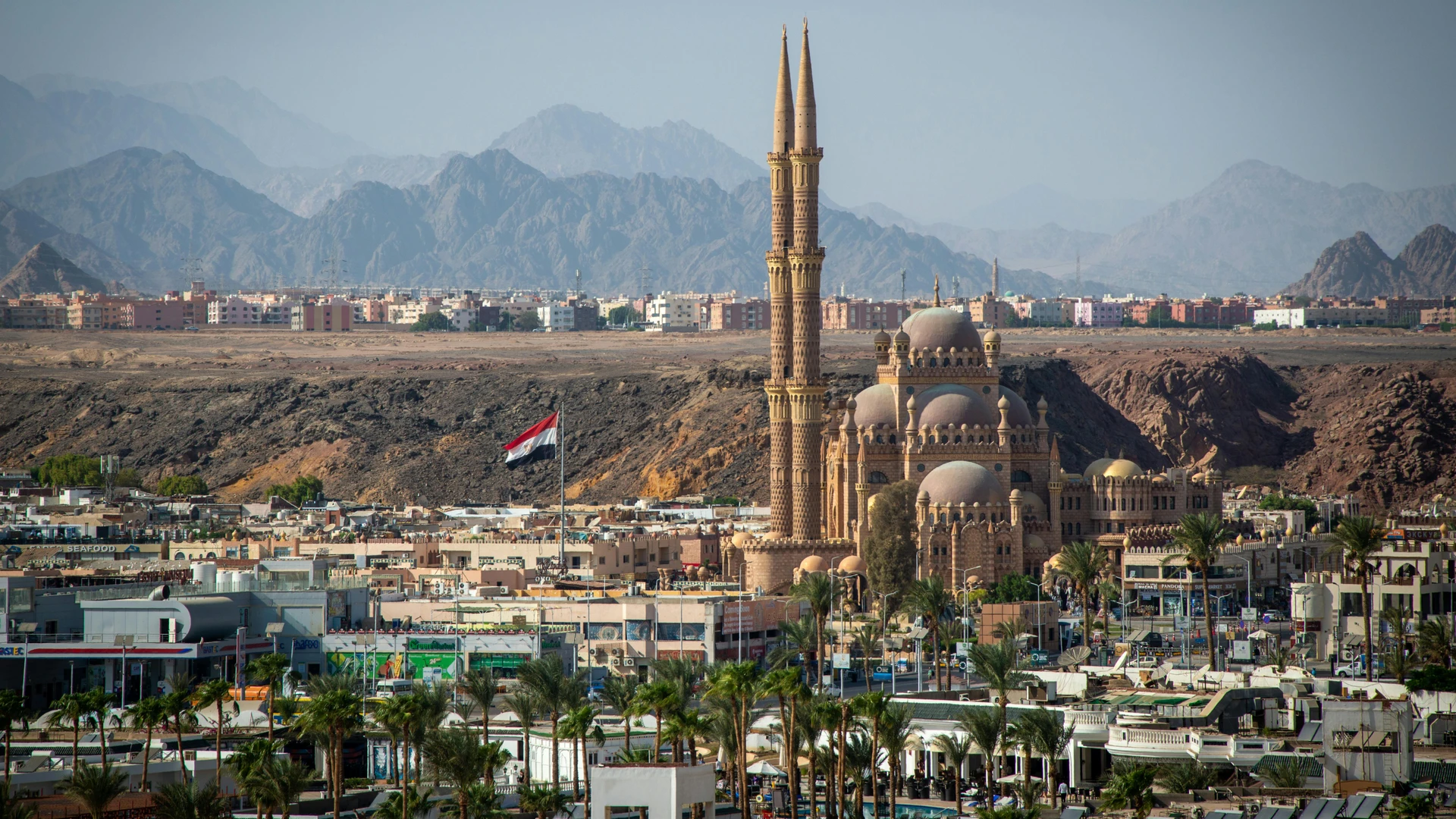 El Gouna, Egypt - Stunning aerial view of al sahaba mosque against sharm el sheikh cityscape and mountains.
