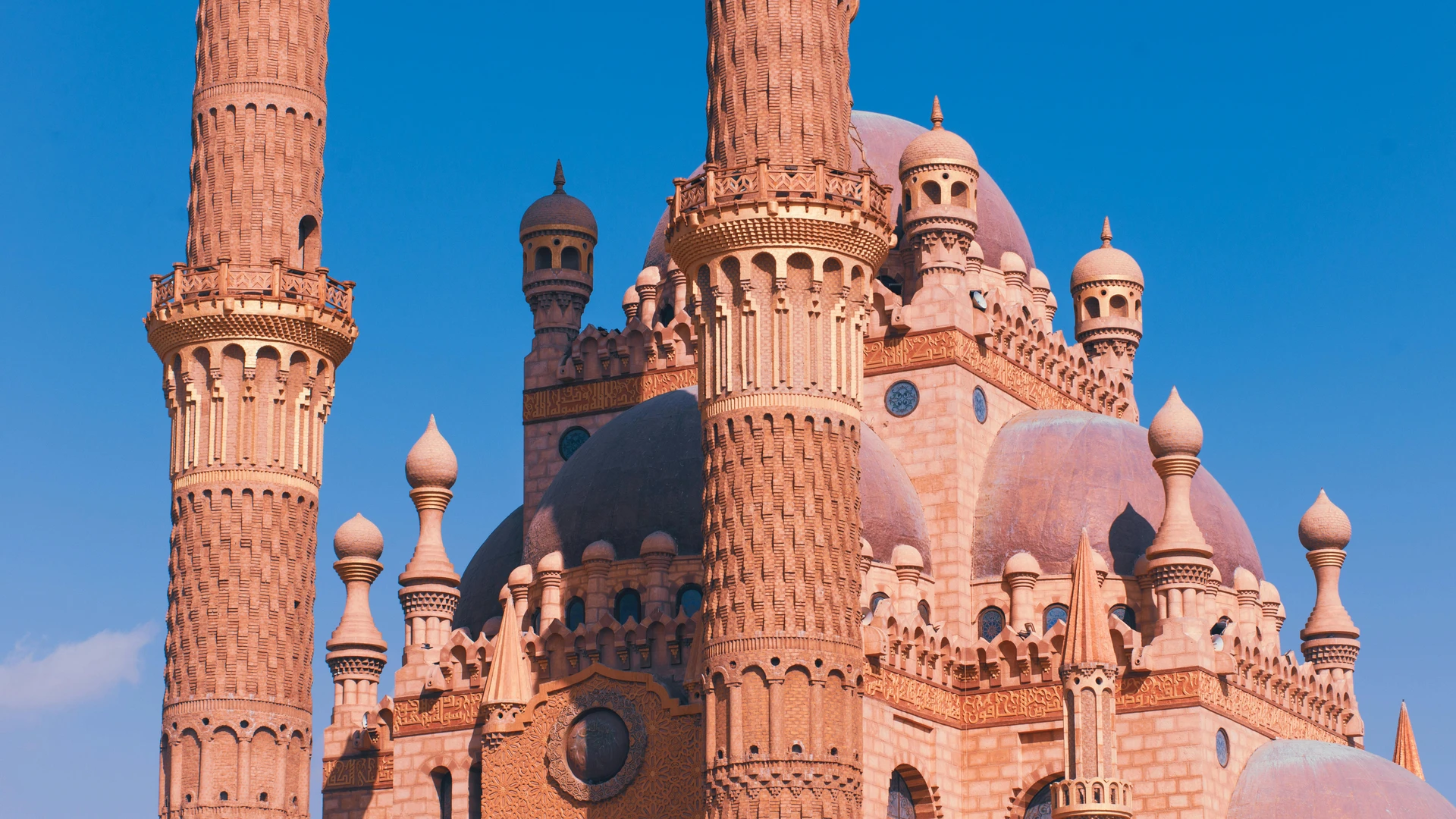 El Gouna, Egypt - Close-up of the sahaba mosque's intricate minarets against a clear blue sky in sharm el sheikh.