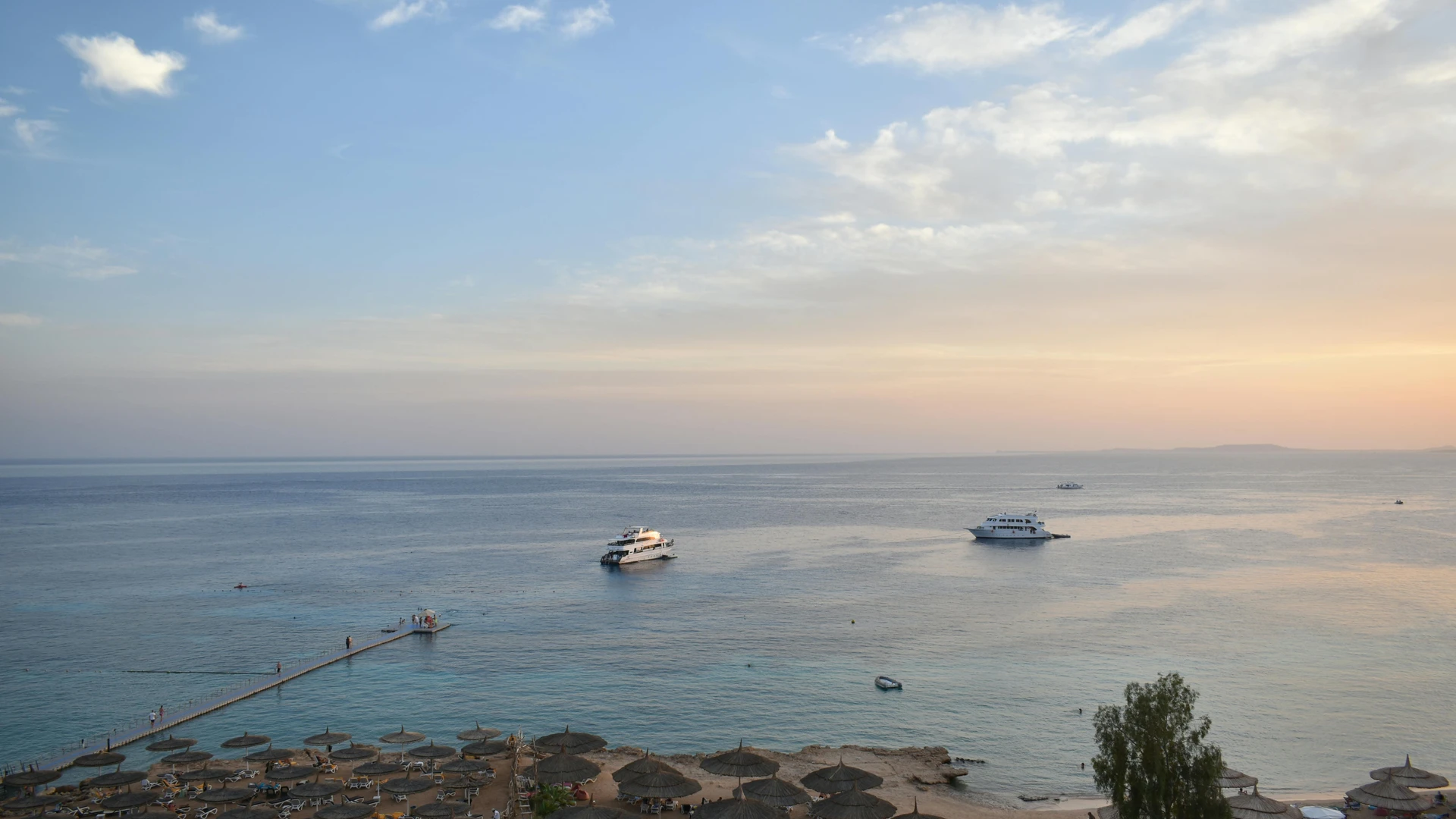 El Gouna, Egypt - Stunning aerial view of sharm el sheikh's beach and sea during sunset with boats and parasols.