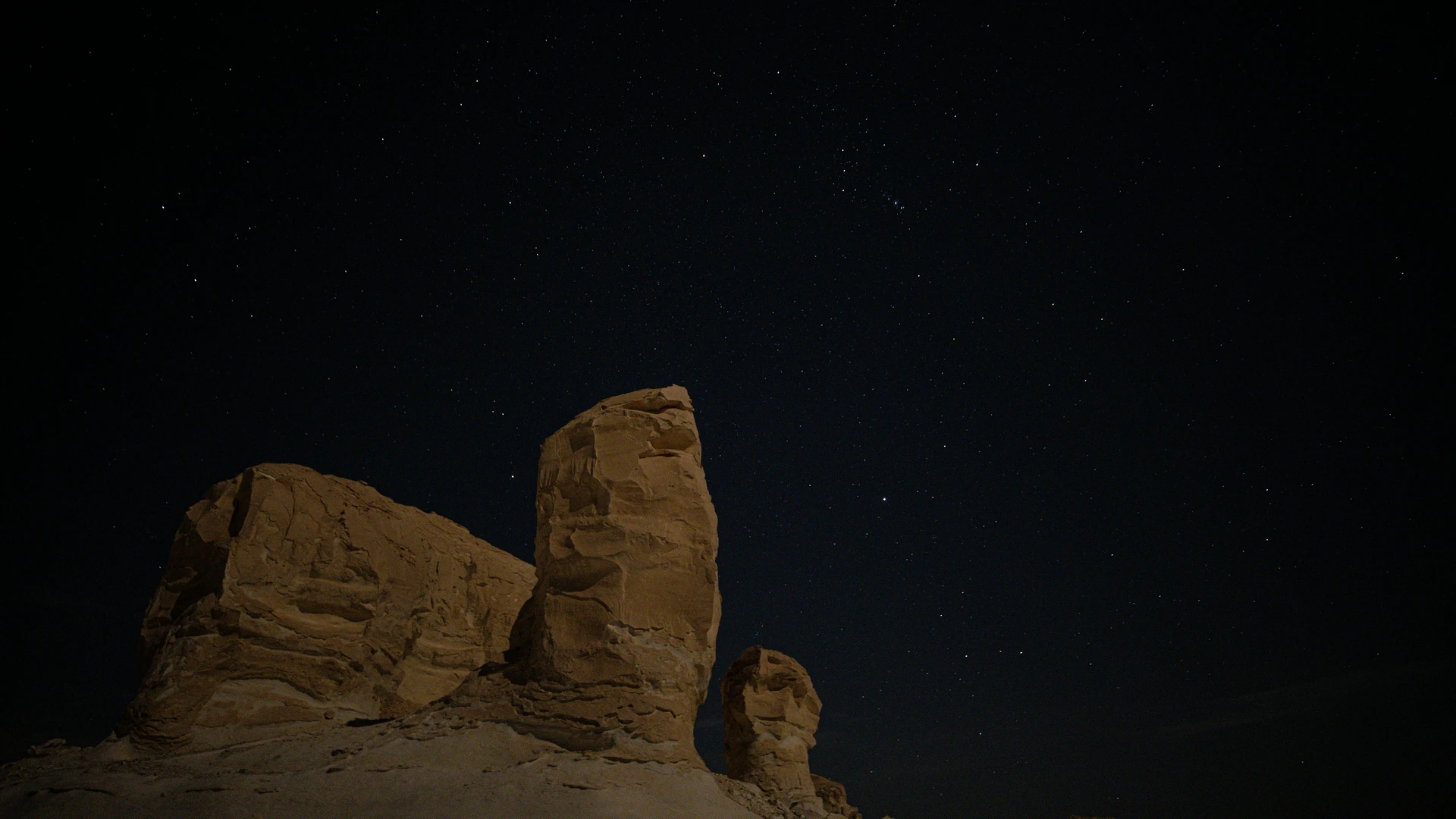 Marsa Alam, Egypt - Night view of natural rock formations under a starry sky at siwa oasis in egypt.