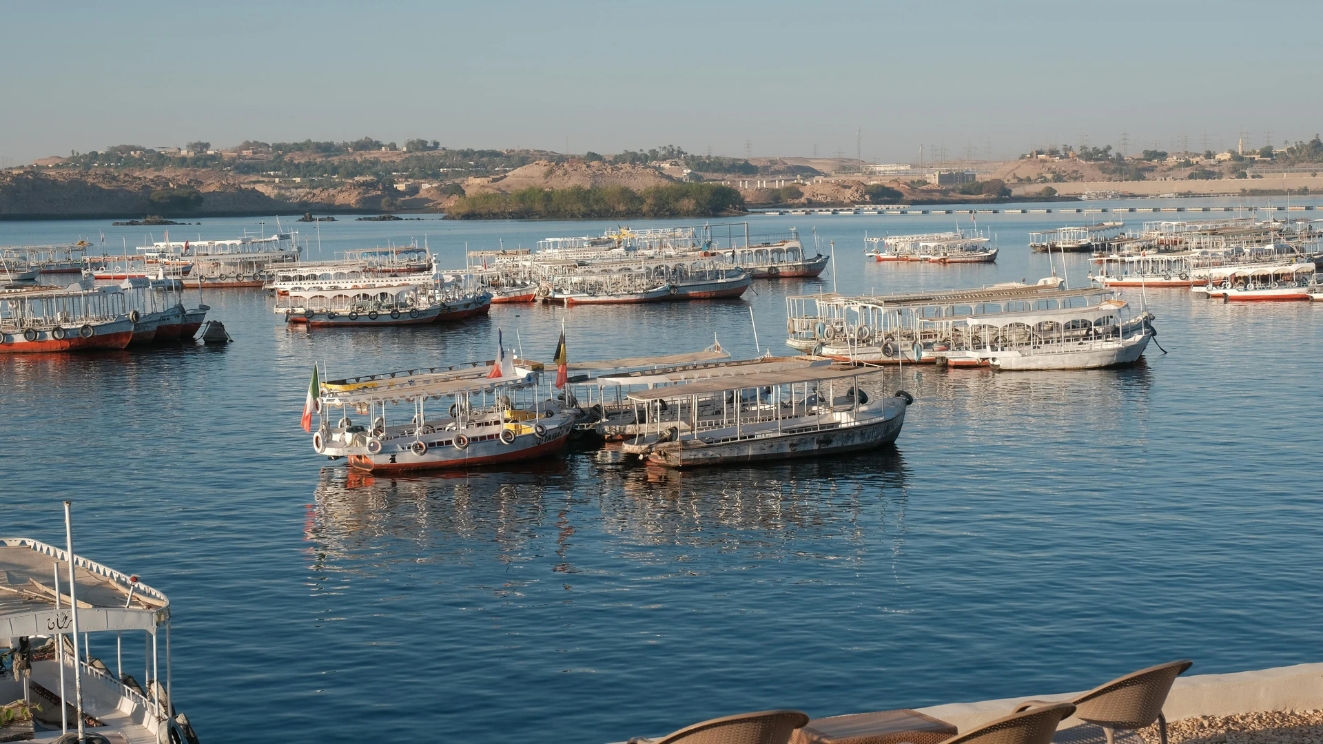 Aswan, Egypt - Tranquil scene of traditional boats on the nile river during sunrise, aswan, egypt.