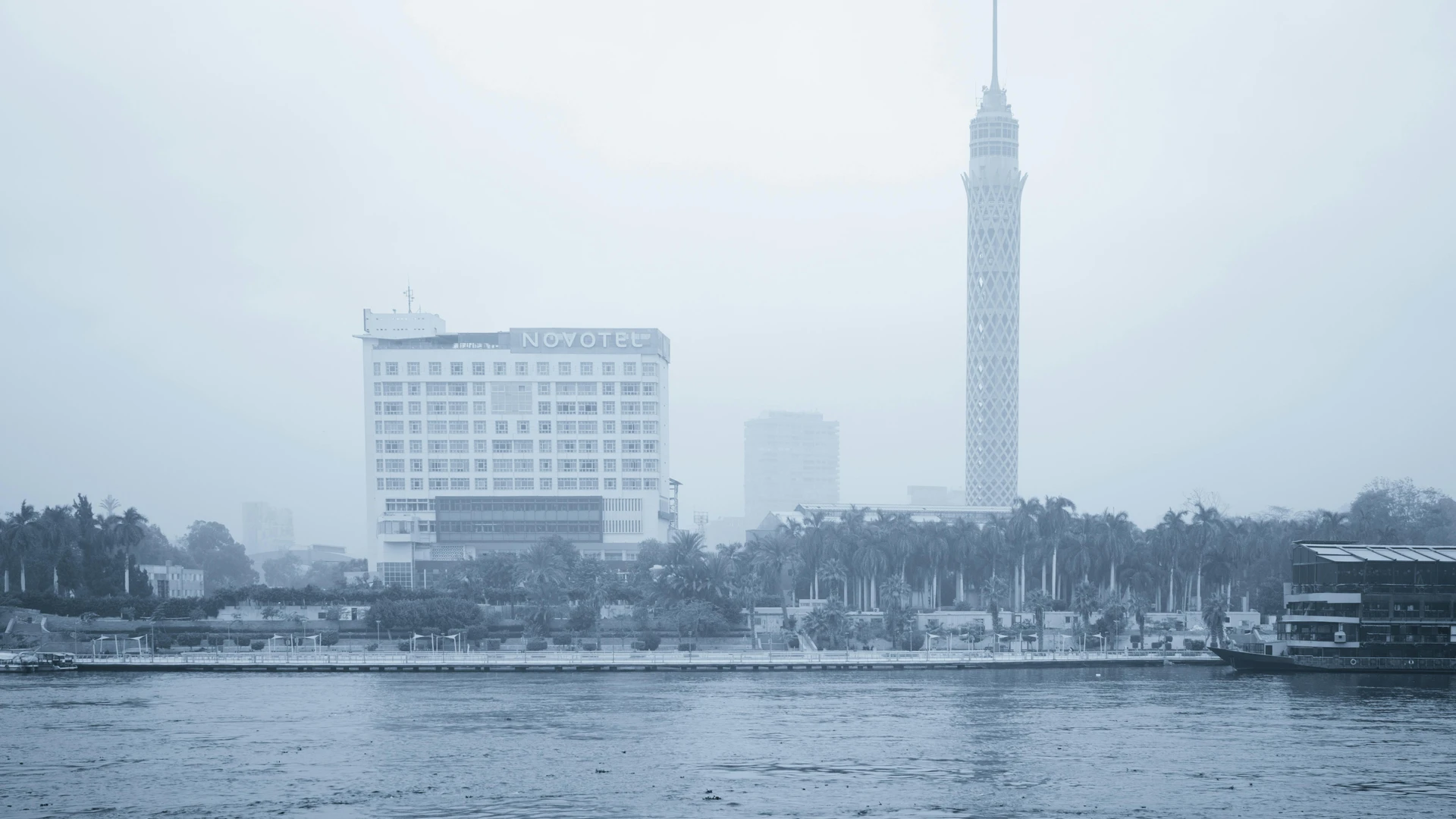 Cairo, Egypt - Foggy cityscape of cairo featuring the cairo tower and novotel by the nile river.