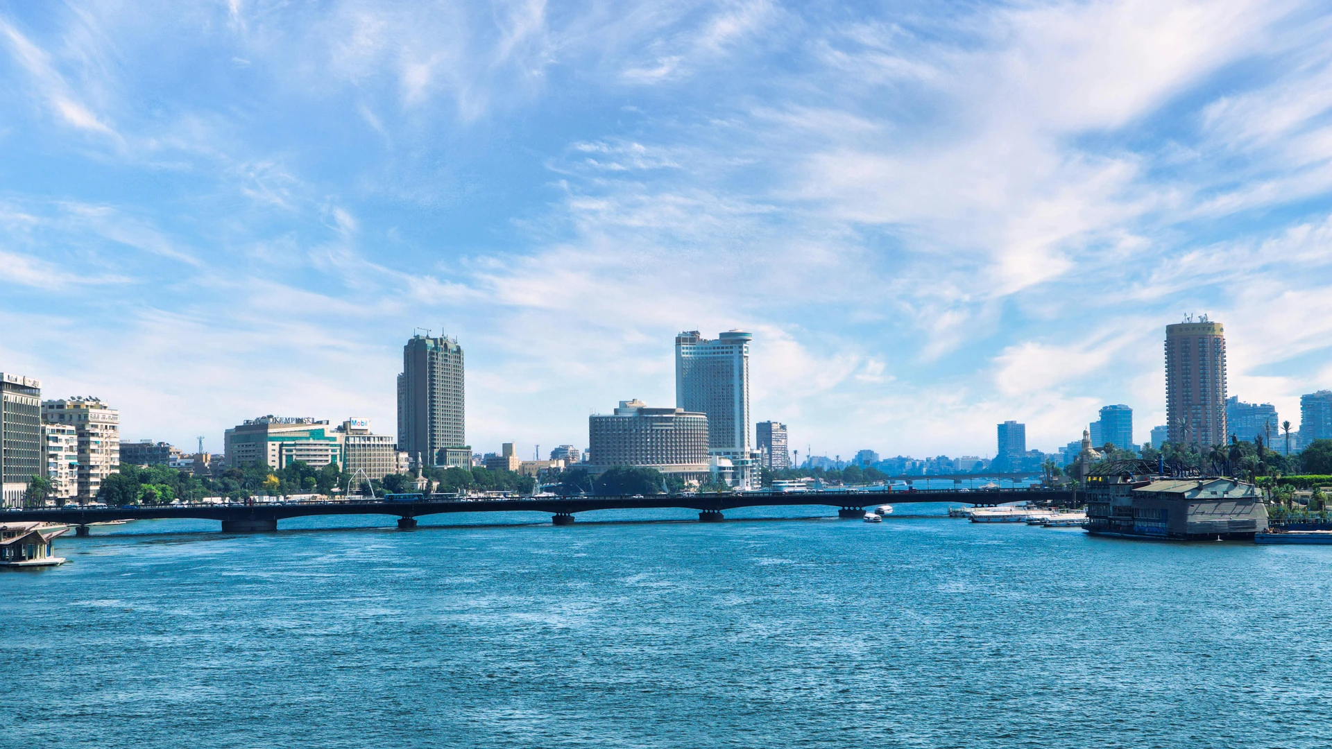 Cairo, Egypt - Discover the stunning cairo skyline with the serene nile river and a clear blue sky backdrop.