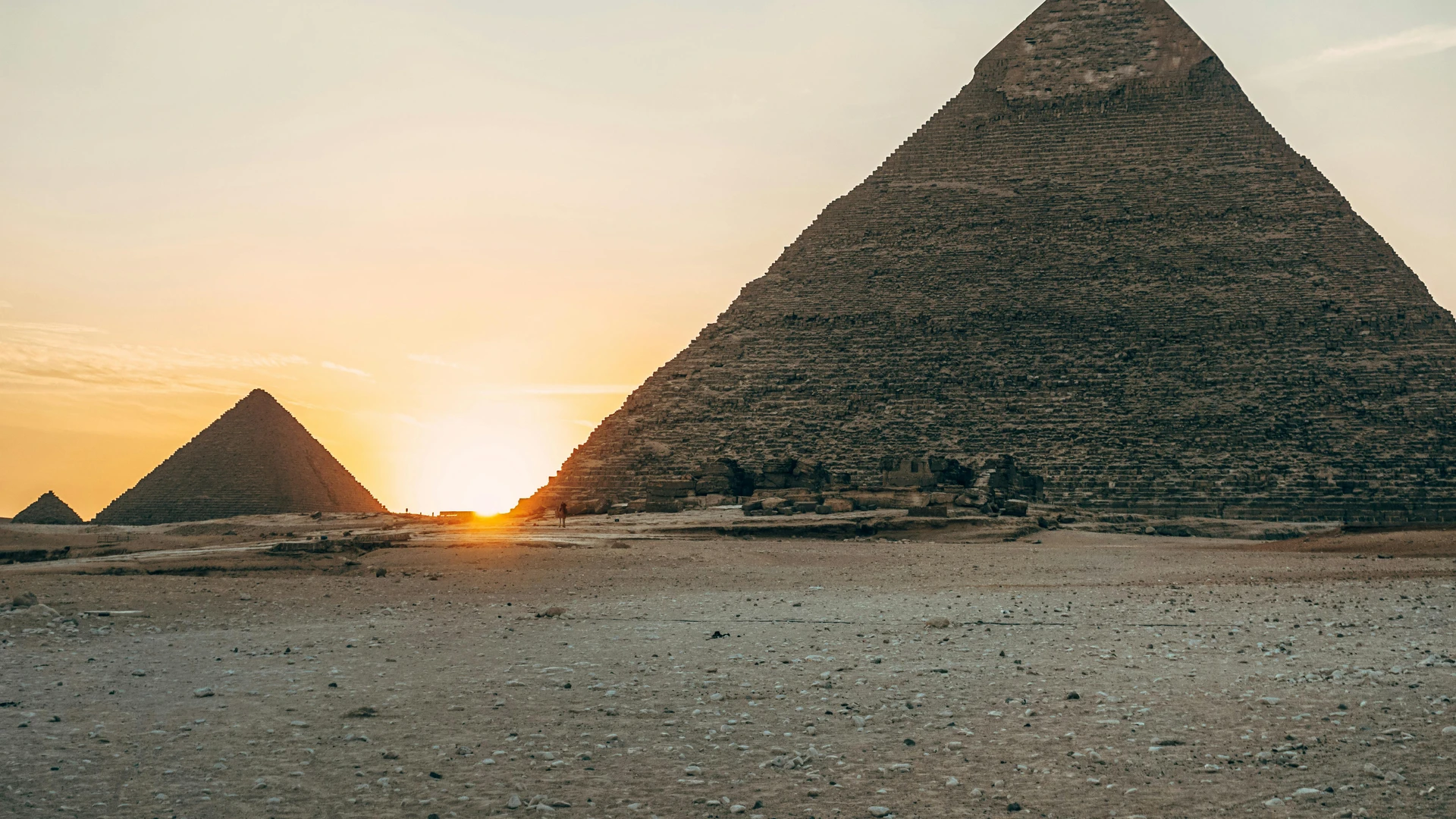 Cairo, Egypt - Dramatic sunset view of the iconic giza pyramids in egypt, highlighting their ancient architecture.