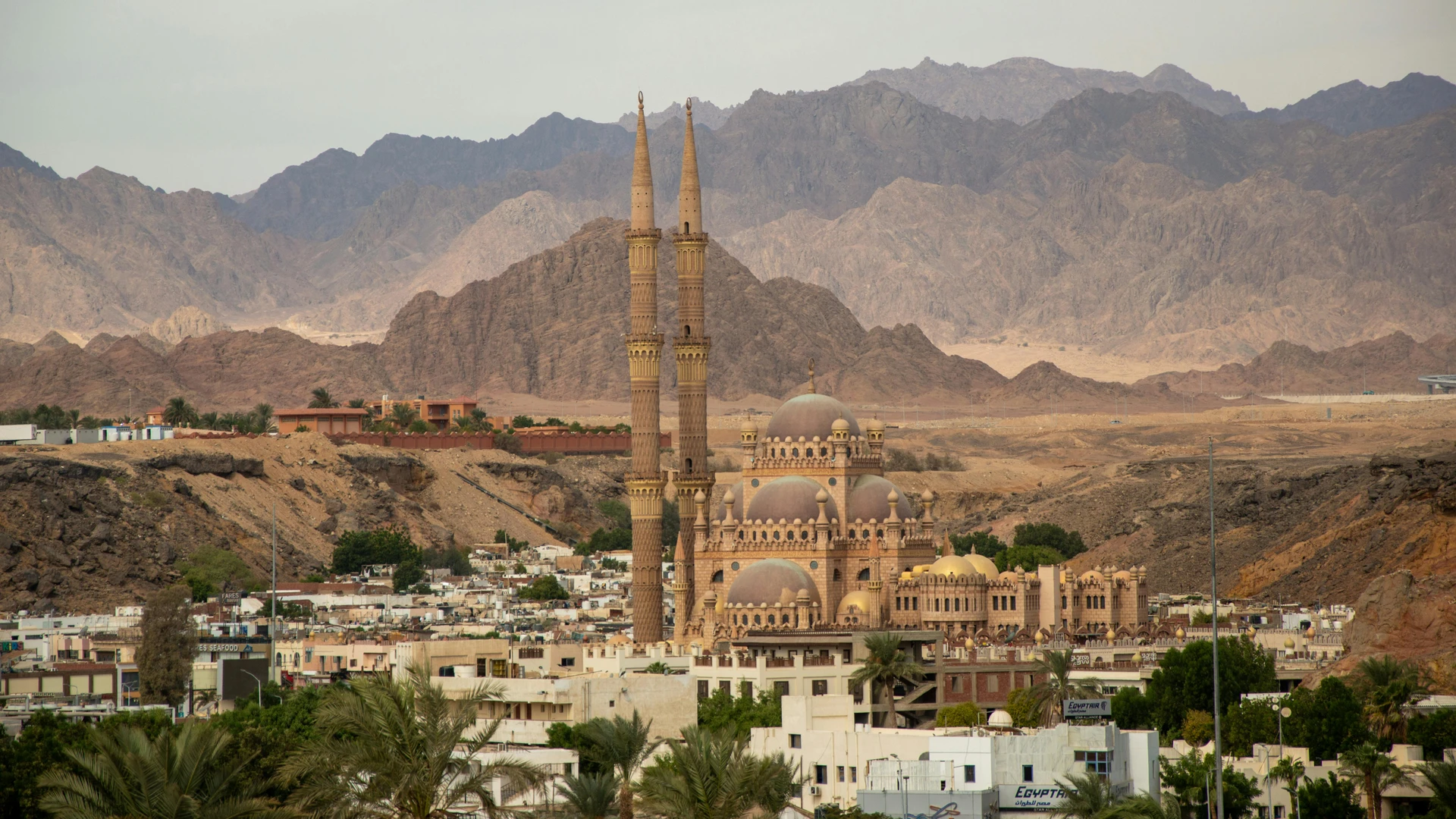 Sharm El Sheikh, Egypt - Grand mosque with tall minarets in sharm el sheikh set against desert mountains.