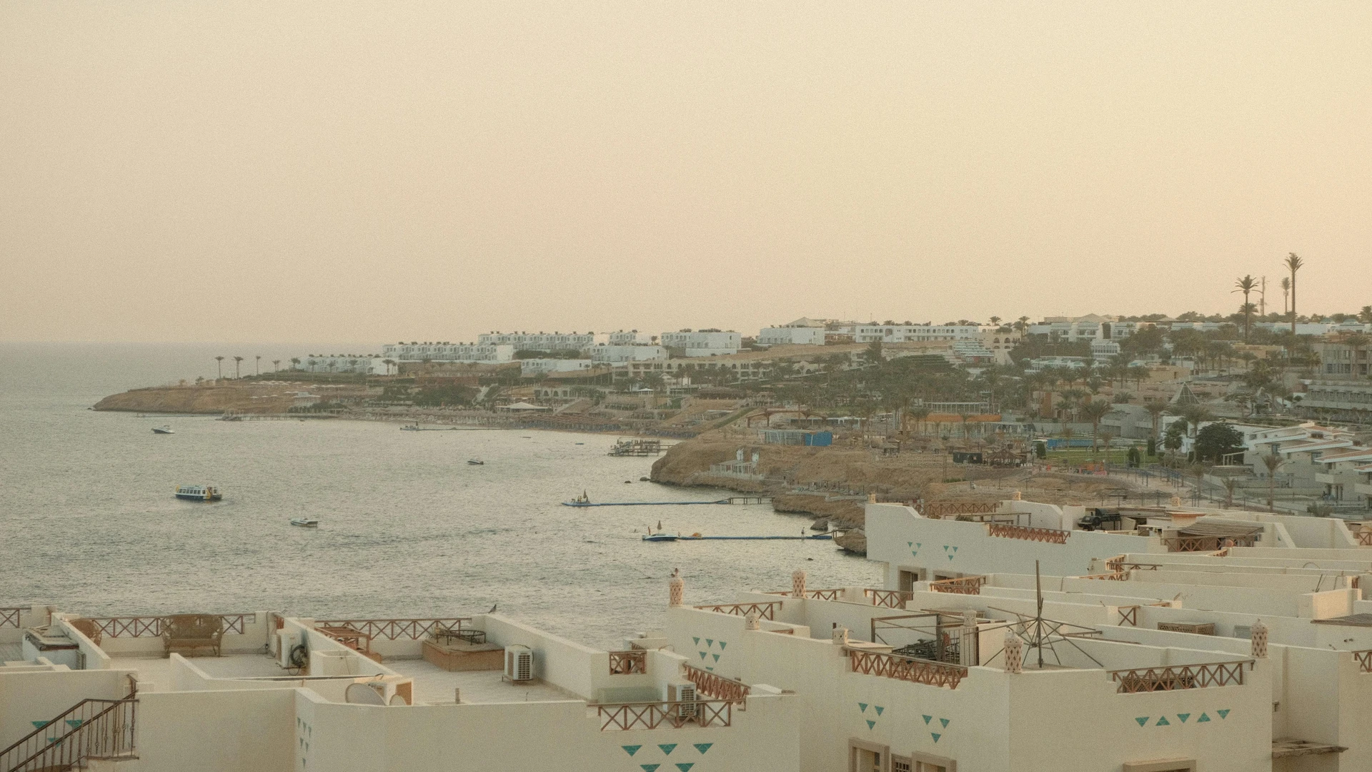 Sharm El Sheikh, Egypt - Breathtaking view of sharm el sheikh coastline at sunset with calm sea and resort buildings.